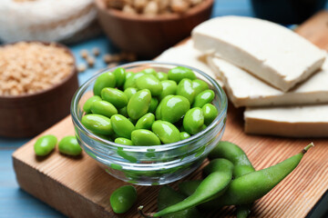Fresh green soy beans and other organic products on light blue table, closeup
