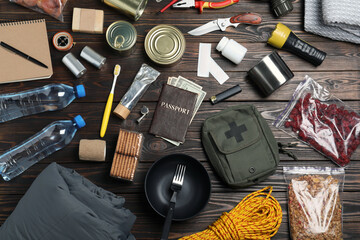 Disaster supply kit for earthquake on wooden table, flat lay