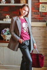 A beautiful girl showing fashionable clothes against the backdrop of the restaurant scenery. Clothes for the showroom