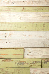 old wooden background of rough boards painted with green and beige paint