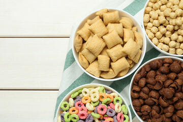 Fototapeta na wymiar Different delicious breakfast cereals on white wooden table, flat lay. Space for text