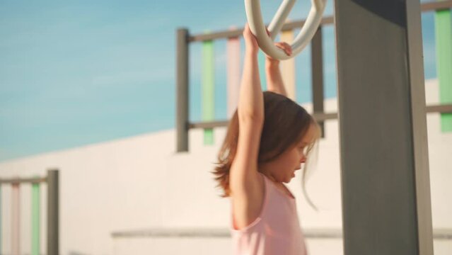 Child playing on playground warm summer day. Little girl have fun. Happy childhood. Caucasian little girl 5 years play outdoor