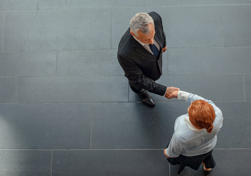 Photo from above of two businessmen shaking hands