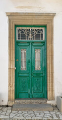 Old green wooden door with glasses. Details Classic vintage door