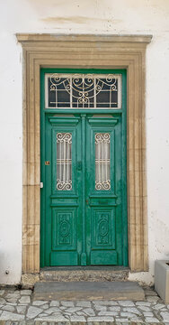 Old green wooden door with glasses. Details Classic vintage door