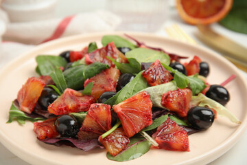 Delicious salad with sicilian orange on white table, closeup