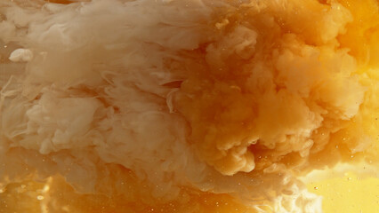 Macro shot of coffee mixing with milk.
