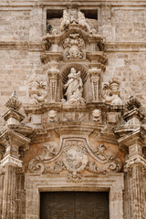 Fototapeta na wymiar Portico of the Parroquia de los Santos Juanes, also known as the church of San Juan del Mercado, located in the city of Valencia, opposite the Lonja de la Seda and next to the Central Market.