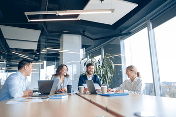 Creative business people working on project in modern office with panoramic view The concept of...
