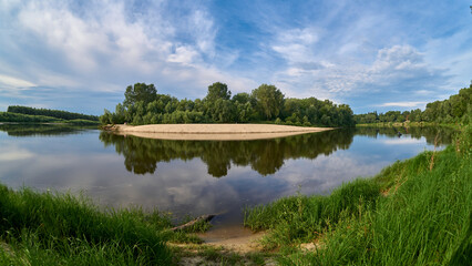 Fototapeta na wymiar green forest reflects in a water of river in Ukraine