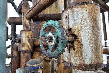 Old pipeline and valves in petrochemical plant.