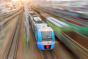 Obraz na płótnie Canvas City train with headlights on rushes along the railway tracks, top aerial view.