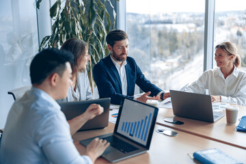 Creative business team working on project in modern office with panoramic view. The concept of...
