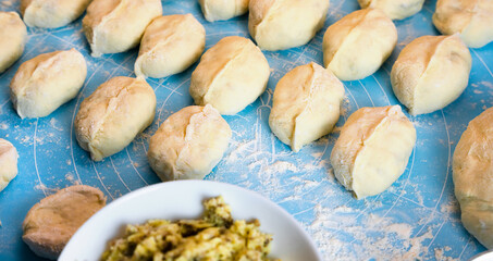The process of cooking pies with potatoes and meat at home. Close-up. Selective focus.