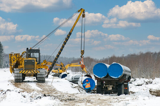 Pipelayer transfers pipes from a truck and lays them out for gas construction. construction site of the main gas pipeline in siberia