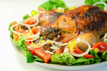 Roasted British large chicken with classic pork, sage, and onion stuffing served with little gem lettuce, tomato, and  fresh onion