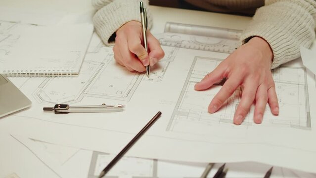 Architect designer drawing close-up. Professional engineer working, interior creator making notes in new house project, blueprint plan, drafting building.