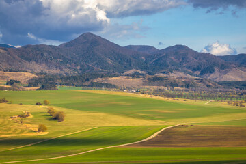Sunny spring rural landscape, valley of fields and meadows with mountains in the background. Turiec Valley in Slovakia, Europe.