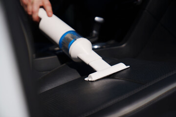 self-service car wash. person vacuuming car cabin after washing 