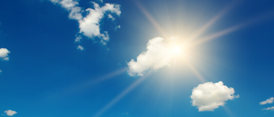 Naklejka na ściany i meble Blue sky with white clouds and bright sun