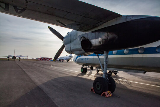 Aktau, Kazakhstan - May 21, 2012: International airport Aktau. Soviet passenger plane Antonov-24 SCAT Airlines company on field. Blue sky.