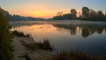 autumn sunrise over the Desna river and ducks in Chernihiv, Ukraine