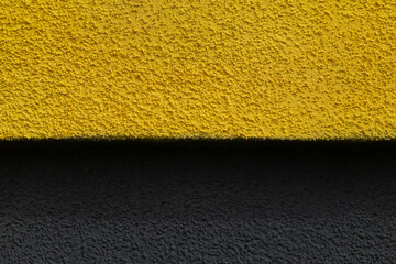 Bright yellow and rich black background.Textured background with a two-color wall pattern.Rough...