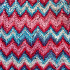 Crocheted dress made of red, pink, blue threads with a zigzag missoni pattern