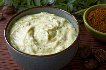 Bechamel sauce with spices: nutmeg and mustard powder blend in a bowl. Homemade white sauce.
