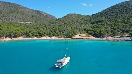 Aerial drone photo of paradise bay and turquoise beach of Dragonera covered in pine trees in small island of Agistri, Greece