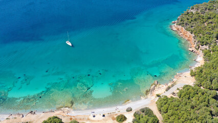 Fototapeta na wymiar Aerial drone photo of paradise bay and turquoise beach of Dragonera covered in pine trees in small island of Agistri, Greece
