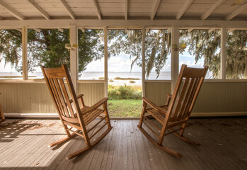 Pair of old rocking chairs on a porch overlooking an inlet at Sapelo Island, Georgia
