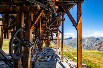 Old wooden structure with the San Juan Mountains in cloudy sky background in Silverton, Colorado