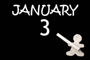 A small white plasticine man writing the date 3 January on a black board. Business concept. Education concept.