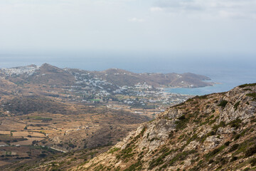 A view of the hazy west coast of Ios Island. Chora town and port in the background. Cyclades, Greece