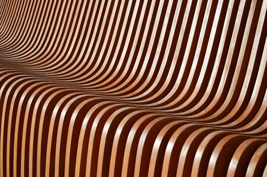 Curved wooden slats. Beautiful gradient from brown to green. Abstract background.
