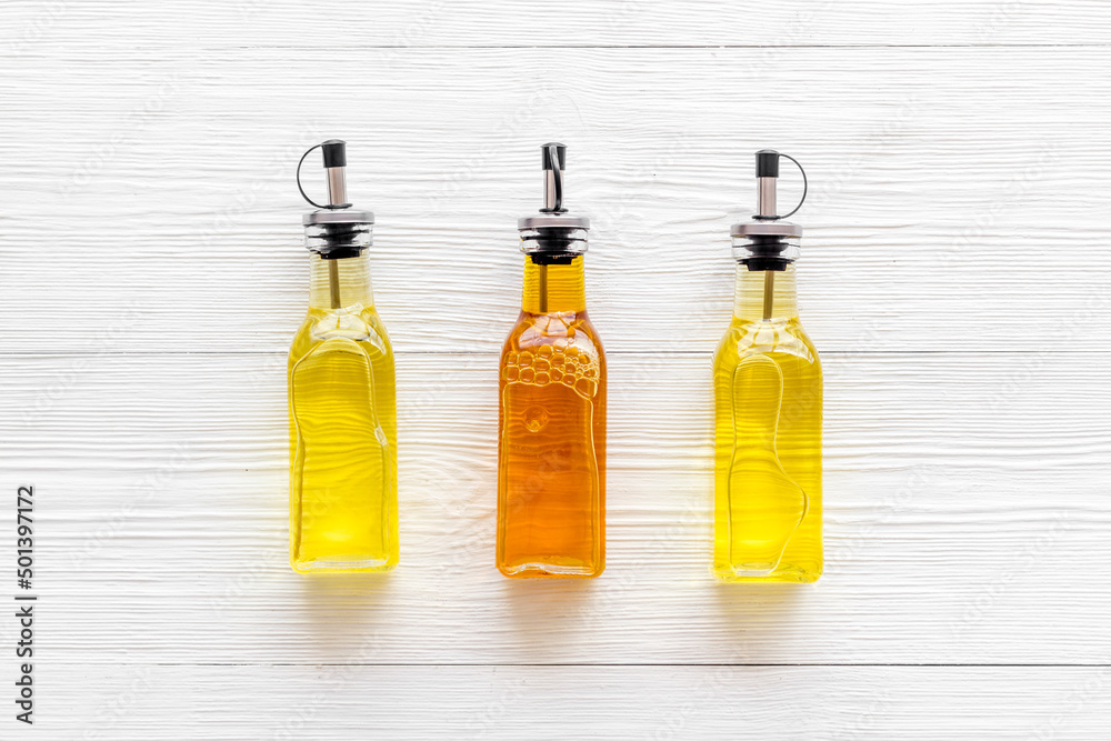 Wall mural Bottles of different types cooking oil. Sunflower olive and sesame oil