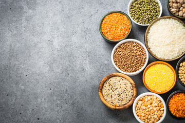 Gluten free food, cereals. Rice, buckwheat, lentils, corn, soy beans and quinoa at stone table. Top view, copy space.