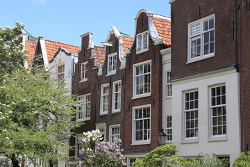 Fototapeta na wymiar Amsterdam Begijnhof Courtyard Historic Brick House Facades with Various Gables, Netherlands