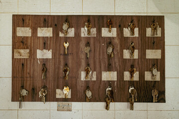Closeup of a wooden board with hanging keys