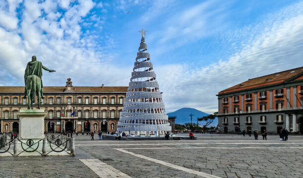 View from Piazza Del Plebiscito in the city center of Naples, Campania, Italy, Europe. Christmas tree on the main square in Napoli. Christmas decoration in winter. View in volcano mount Vesuvius