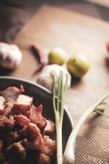 Fried Pork Belly with Fish Sauce Served on a Gray plate on a black wooden floor.