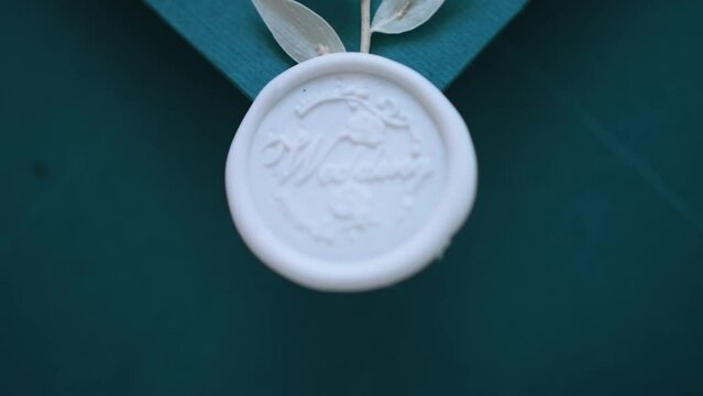 Rubber stamp close up. Embossing on the envelope with a stamp. The word wedding is written on the seal. Stationery decor elements. Artistic effect of defocus