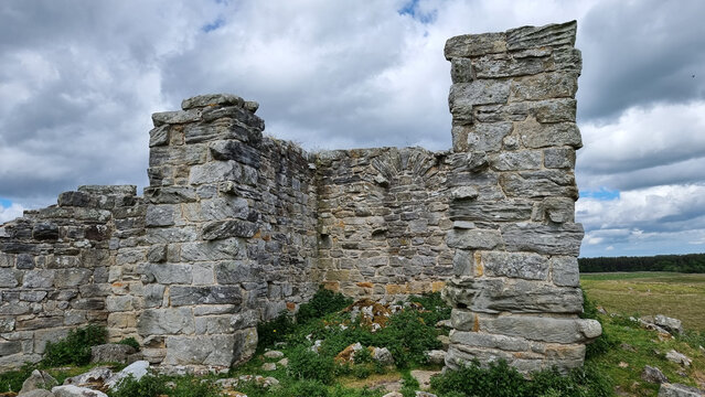 Beautiful shot of a Rothley Castle with a green grass field and a blue sky with clouds