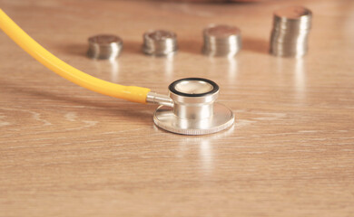 Piggy bank with stethoscope, tax offset concept