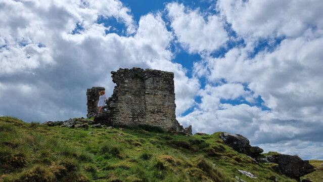 Beautiful shot of a Rothley Castle with a green grass field and a blue sky with clouds