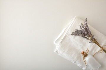 Clean clothes concept with natural soap and lavender on towel