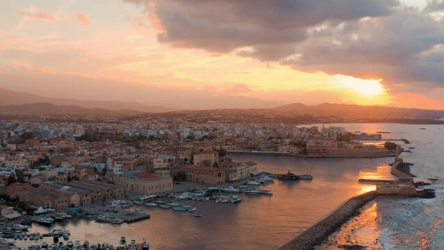 View of Chania, Greece. Port, bay, sunset, sky, clouds, sun, boats, tourist place, drone, aerial, summer, greek city - 4K Drone Video Footage