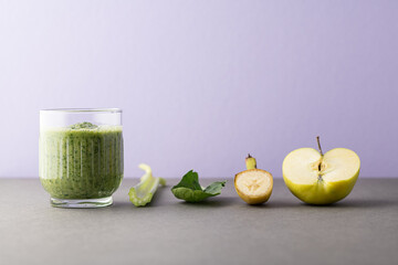 Composition with a glass of delicious detox juice (smoothie) and ingredients on colour background