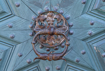 Old rusty doorknob and wooden door
